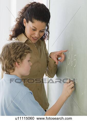 Hispanic teacher helping student with math problem View Large Photo Image Stock Image - Hispanic teacher helping student with math problem. Fotosearch