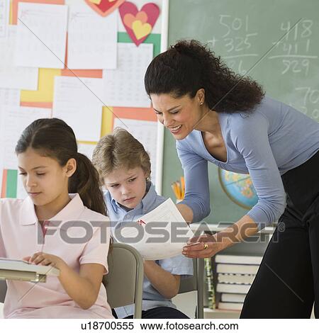 Stock Photography - Hispanic teacher talking to student. Fotosearch