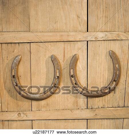 Stock Photo - Horseshoes hanging on wall. Fotosearch