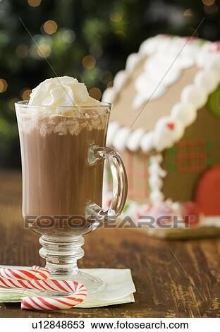 Hot chocolate with whipped cream next to gingerbread house View Large Photo Image Stock Image - Hot chocolate with whipped cream next to gingerbread house. Fotosearch