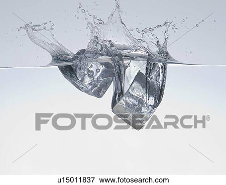 Stock Photo - Ice cubes splashing in water. Fotosearch