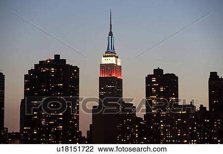 Stock Image - Illuminated Empire State Building at dusk. Fotosearch