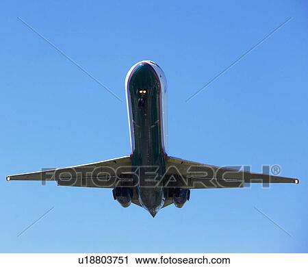 Stock Image - Low angle view of airplane in sky. Fotosearch