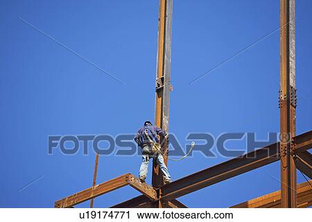 Low angle view of construction worker on beam View Large Photo Image Stock Image - Low angle view of construction worker on beam. Fotosearch
