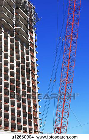 Picture - Low angle view of crane and apartment building, New York City, New York, United States. Fotosearch