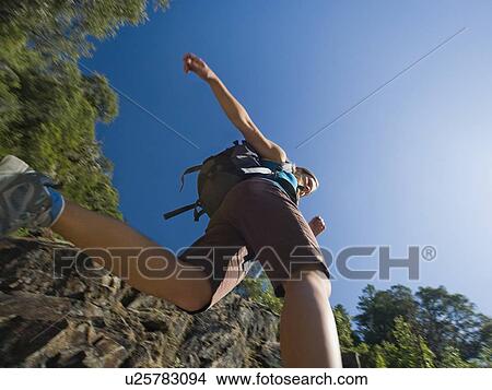 Low angle view of female hiker View Large Photo Image Picture - Low angle view of female hiker. Fotosearch