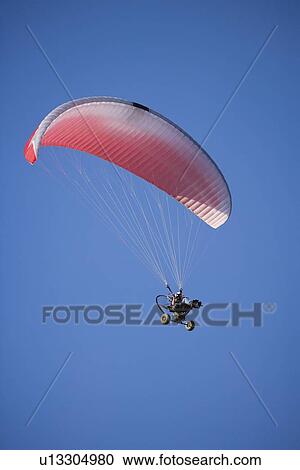 Low angle view of paraglider in air View Large Photo Image Stock Image - Low angle view of paraglider in air. Fotosearch