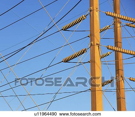Stock Image - Low angle view of power lines on poles. Fotosearch