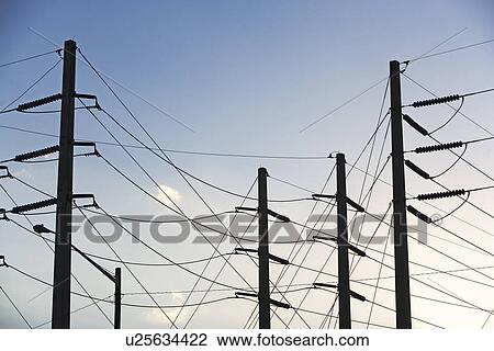 Stock Image - Low angle view of power lines on poles. Fotosearch