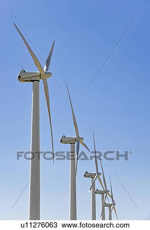 Stock Image - Low angle view of wind turbines. Fotosearch