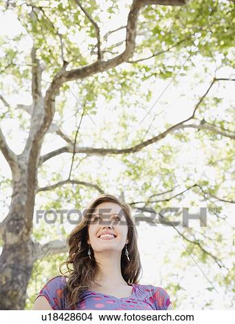 Low angle view of woman in park View Large Photo Image Picture - Low angle view of woman in park. Fotosearch