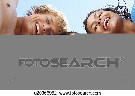 Low angle view of young friends in huddle View Large Photo Image Stock Image - Low angle view of young friends in huddle. Fotosearch