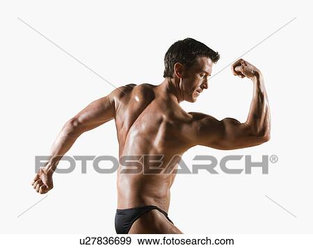 Male body builder flexing and posing View Large Photo Image Stock Photo - Male body builder flexing and posing. Fotosearch