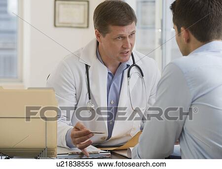 Stock Photography - Male doctor consulting female patient. Fotosearch