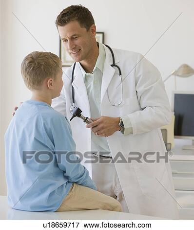 Stock Photo - Male doctor examining boy. Fotosearch