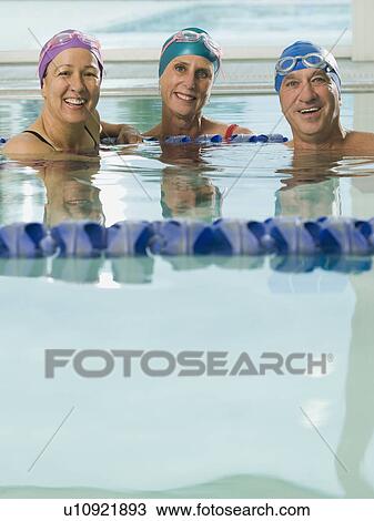 Man and women posing in swimming pool View Large Photo Image Stock Image - Man and women posing in swimming pool. Fotosearch