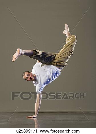 Man balancing on one hand View Large Photo Image Stock Image - Man balancing on one hand. Fotosearch
