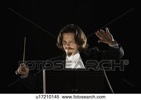 Stock Photography - Man conducting behind music stand. Fotosearch