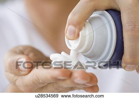 Stock Photo - Man dispensing shaving cream into hand. Fotosearch