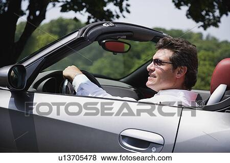 Man driving convertible car View Large Photo Image Stock Photo - Man driving convertible car. Fotosearch