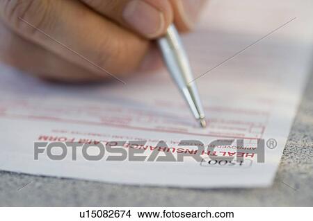 Man filling out health insurance claim form View Large Photo Image Picture - Man filling out health insurance claim form. Fotosearch