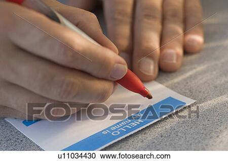 Man filling out name tag View Large Photo Image Stock Image - Man filling out name tag. Fotosearch