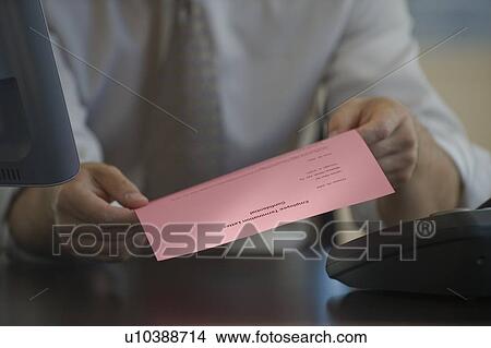 Picture - Man holding pink slip. Fotosearch