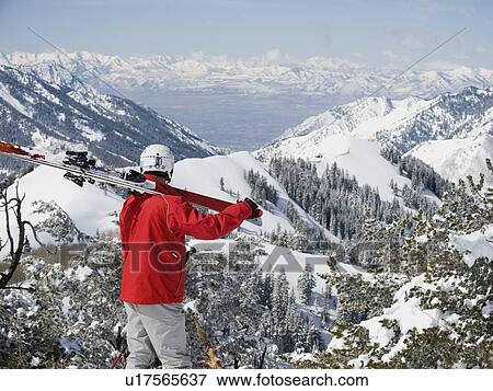 Stock Photo - Man holding skis on shoulder. Fotosearch