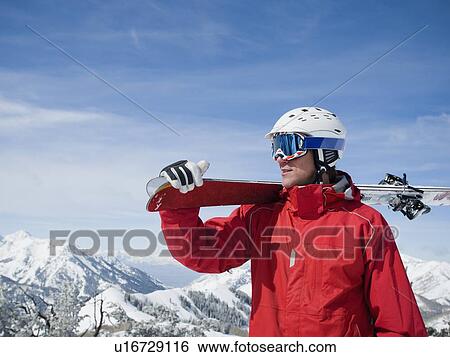 Man holding skis on shoulder View Large Photo Image Stock Photograph - Man holding skis on shoulder. Fotosearch