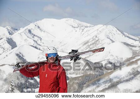 Stock Photograph - Man holding skis on shoulder. Fotosearch
