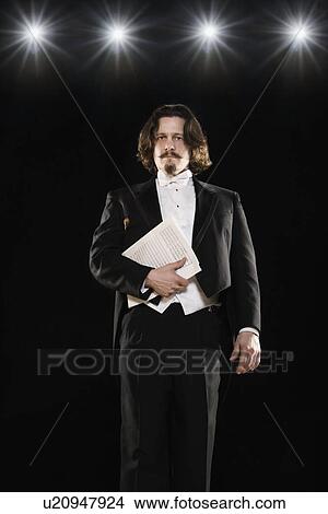 Man in tuxedo holding sheet music View Large Photo Image Picture - Man in tuxedo holding sheet music. Fotosearch