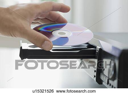 Man inserting dvd View Large Photo Image Stock Photograph - Man inserting dvd. Fotosearch
