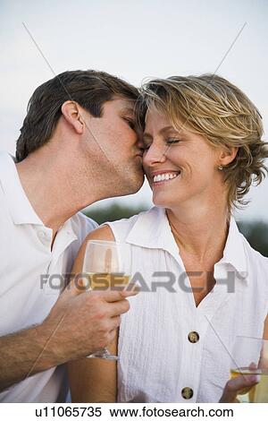 Man kissing wife’s cheek View Large Photo Image Stock Photography - Man kissing wife’s cheek. Fotosearch