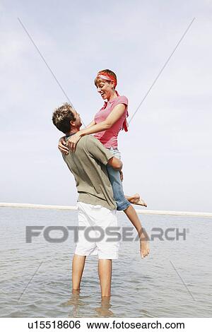 Man lifting ocean out of ocean View Large Photo Image Stock Photograph - Man lifting ocean out of ocean. Fotosearch