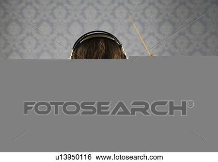 Man listening to headphones and conducting View Large Photo Image Stock Photograph - Man listening to headphones and conducting. Fotosearch