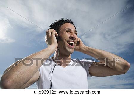 Stock Photography - Man listening to headphones. Fotosearch