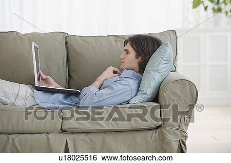 Man looking at laptop View Large Photo Image Stock Photograph - Man looking at laptop. Fotosearch