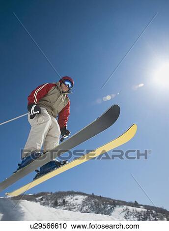 Stock Image - Man on skis in air. Fotosearch