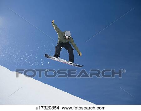 Man on snowboard in air View Large Photo Image Picture - Man on snowboard in air. Fotosearch