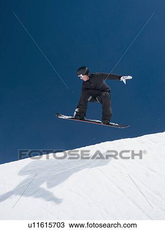 Man on snowboard in air View Large Photo Image Stock Image - Man on snowboard in air. Fotosearch