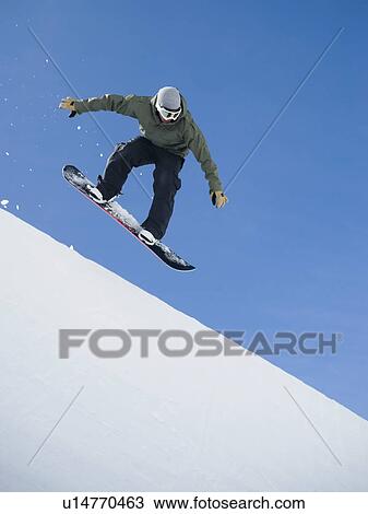 Stock Image - Man on snowboard in air. Fotosearch