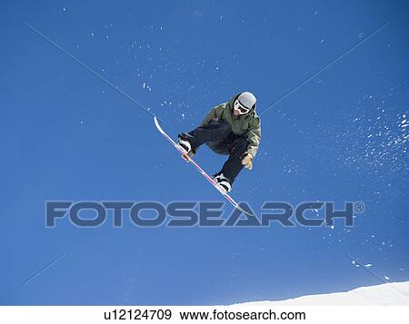 Man on snowboard in air View Large Photo Image Stock Photo - Man on snowboard in air. Fotosearch