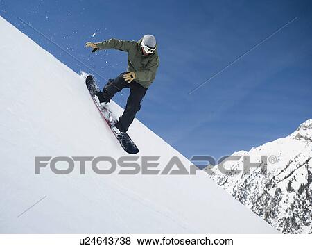 Man on snowboard in air View Large Photo Image Stock Photo - Man on snowboard in air. Fotosearch