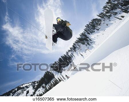 Man on snowboard in air View Large Photo Image Stock Photography - Man on snowboard in air. Fotosearch