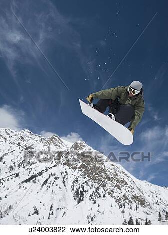 Man on snowboard in air, Wasatch Mountains, Utah, United States View Large Photo Image Stock Image - Man on snowboard in air, Wasatch Mountains, Utah, United States. Fotosearch