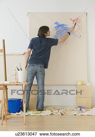 Man painting on easel View Large Photo Image Stock Photo - Man painting on easel. Fotosearch