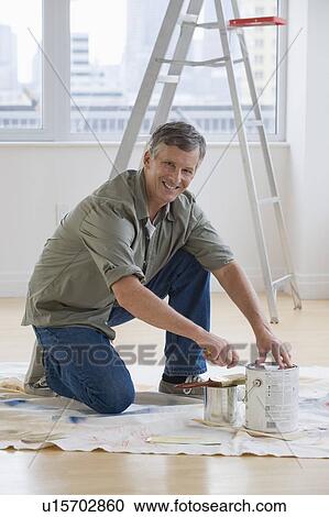 Stock Image - Man painting room. Fotosearch