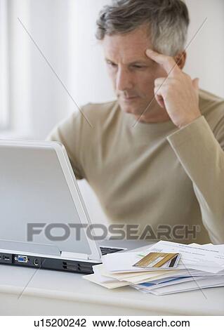 Man paying bills online View Large Photo Image Stock Image - Man paying bills online. Fotosearch