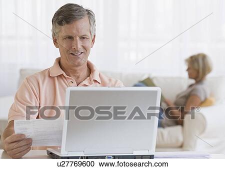 Man paying bills online View Large Photo Image Stock Image - Man paying bills online. Fotosearch