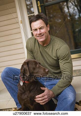 Man petting dog outdoors View Large Photo Image Stock Photo - Man petting dog outdoors. Fotosearch